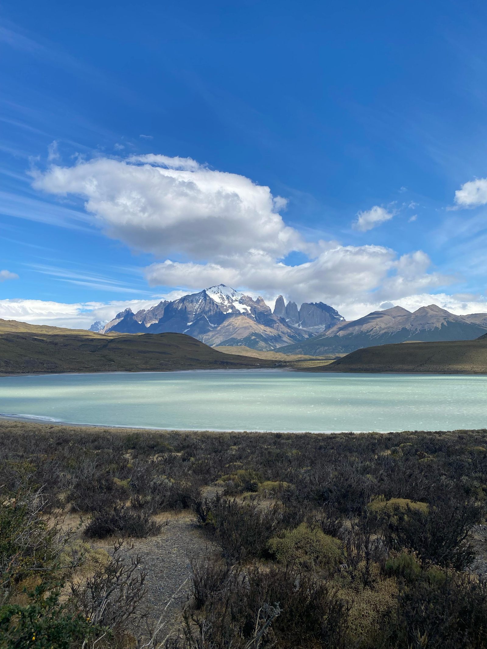 Patagonian lake with the Paine massif behind, seen from a gravel road