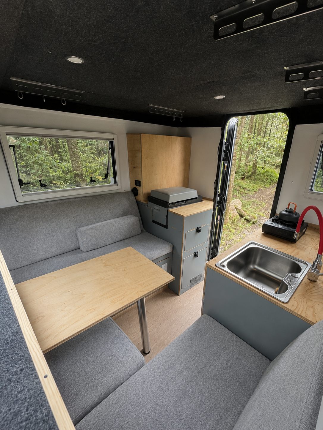 Nomads L interior dinette and sleeping area